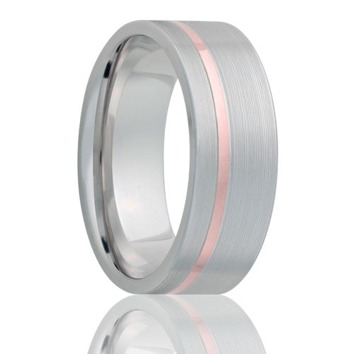 A cobalt wedding band with asymmetrical 14k rose gold groove inlay displayed on a neutral white background.