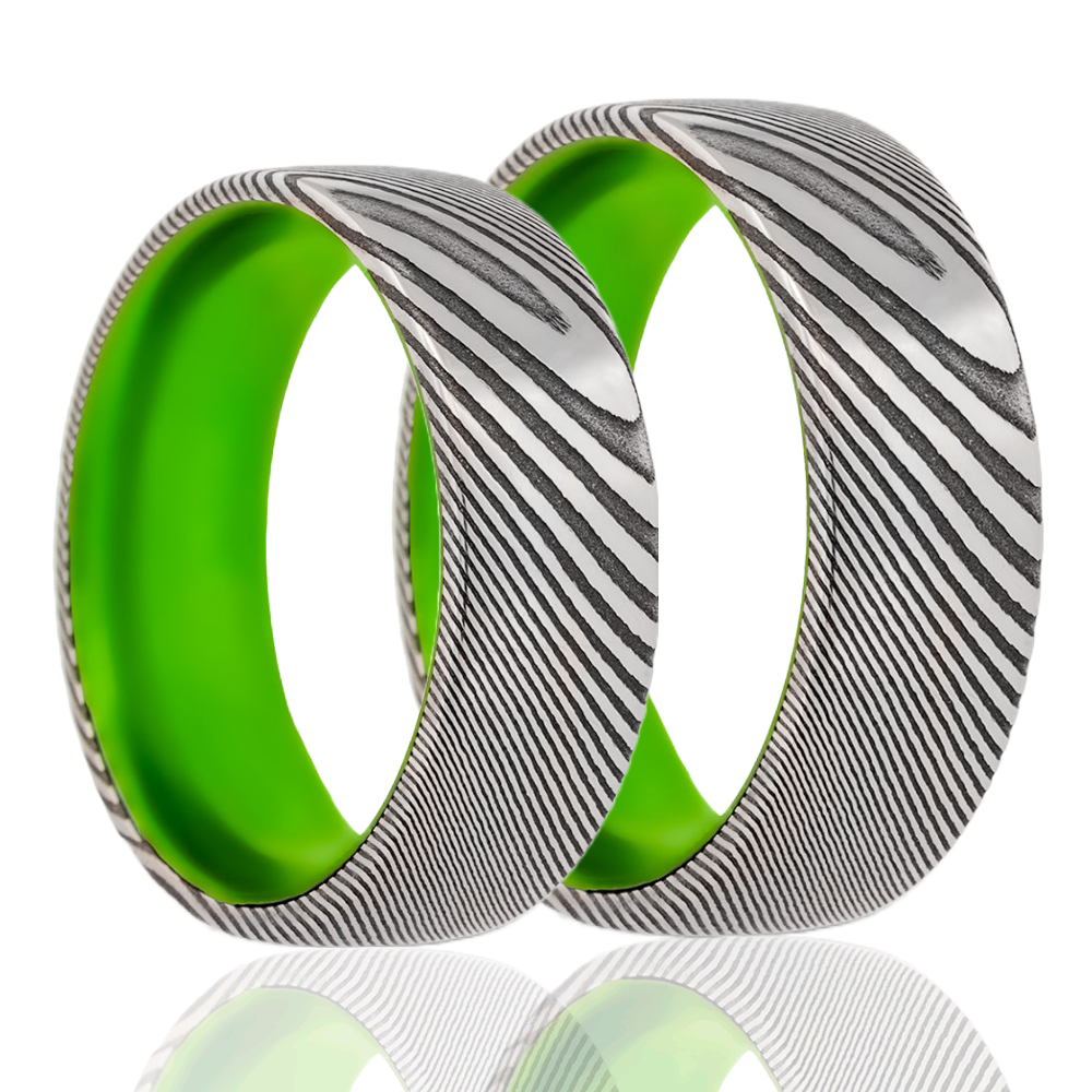 A damascus steel contrasting center couple's matching wedding band set displayed on a neutral white background.