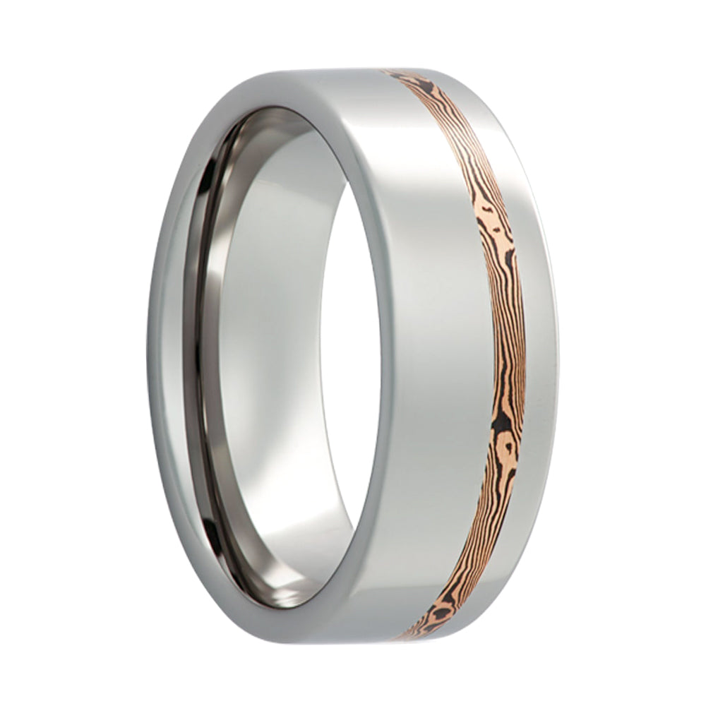 A asymmetrical shakudo & 14k rose gold mokume gane inlay cobalt wedding band displayed on a neutral white background.