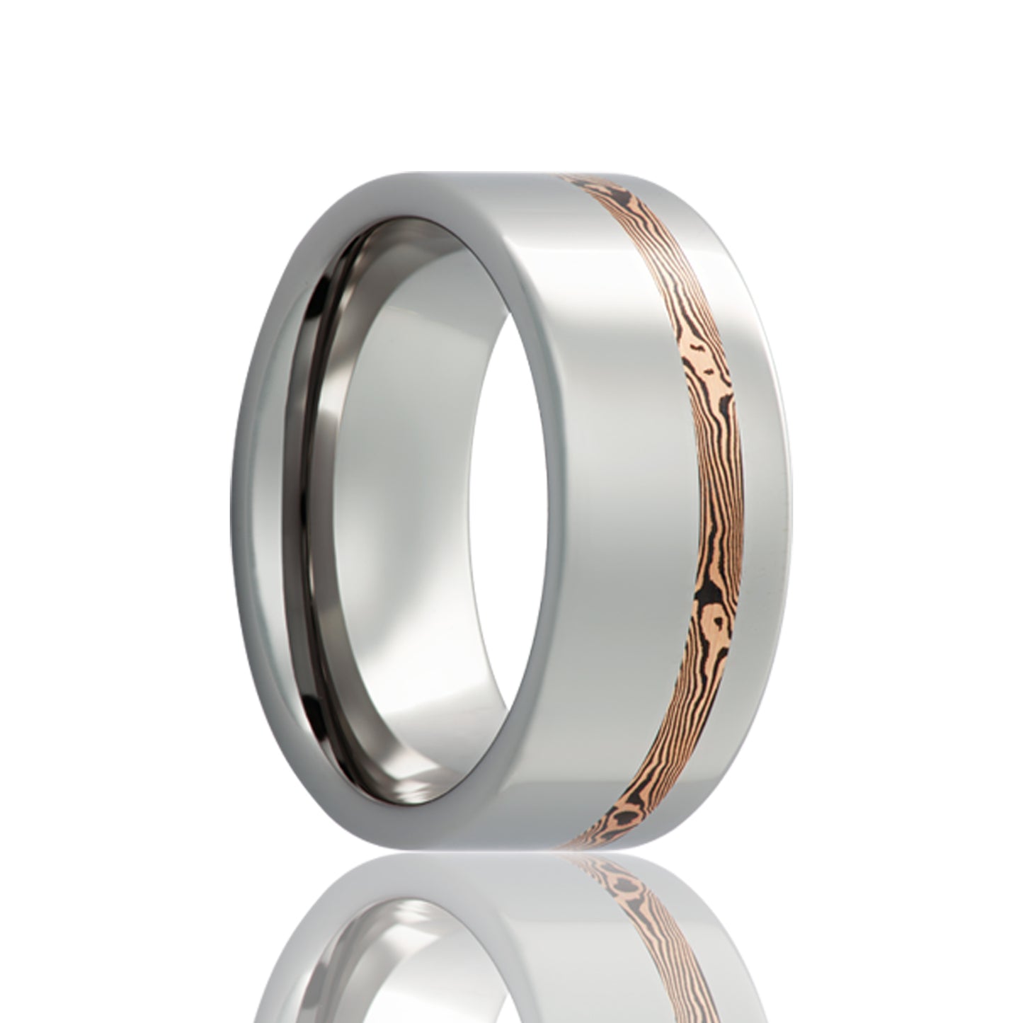 A asymmetrical shakudo & 14k rose gold mokume gane inlay cobalt wedding band displayed on a neutral white background.