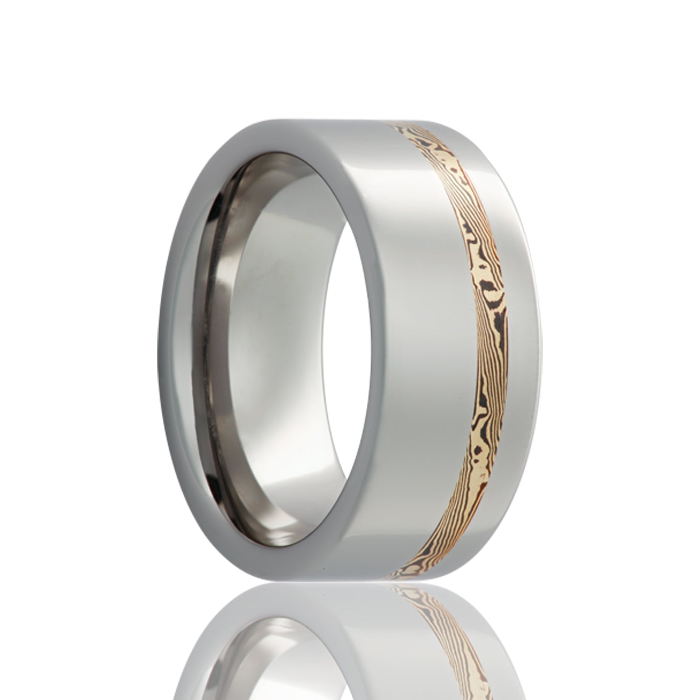 A asymmetrical 14k yellow gold & shakudo mokume gane inlay cobalt wedding band displayed on a neutral white background.