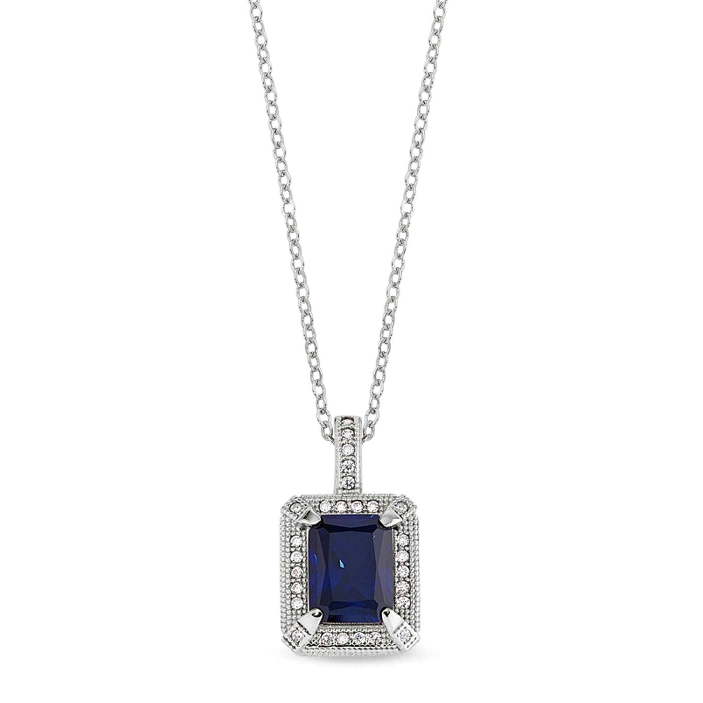 A emerald cut synthetic blue corrundum pendant with simulated diamonds displayed on a neutral white background.