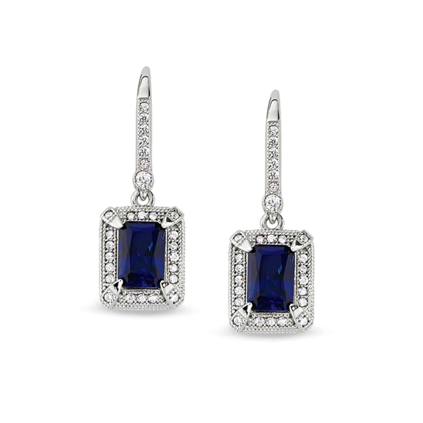 A emerald cut synthetic blue sapphire earrings with simulated diamonds displayed on a neutral white background.