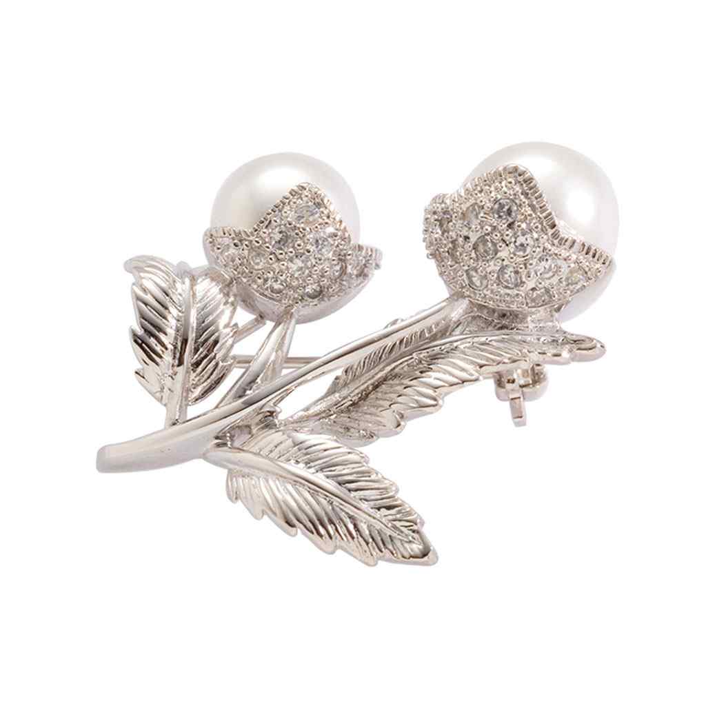 A ornate flower pin with glass pearls displayed on a neutral white background.