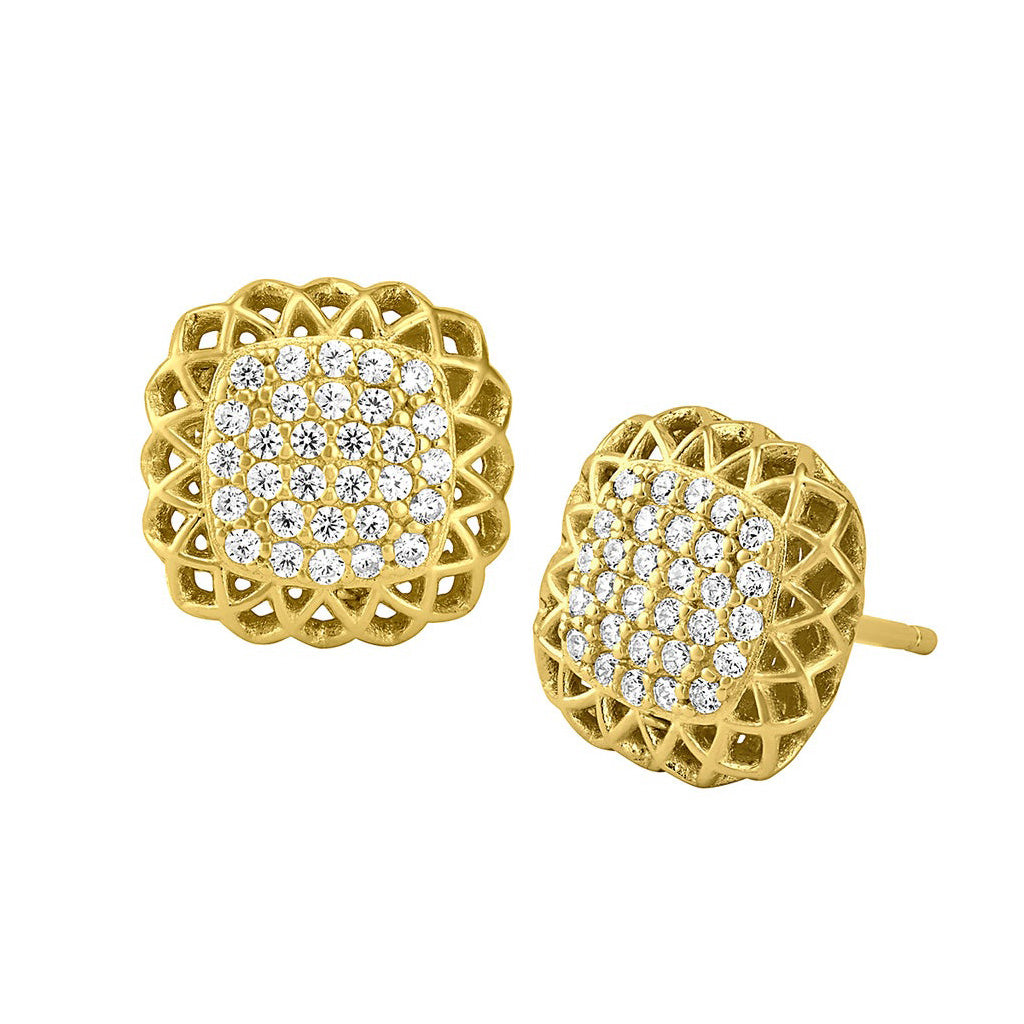 A pillow with filigree edge earrings with simulated diamonds displayed on a neutral white background.