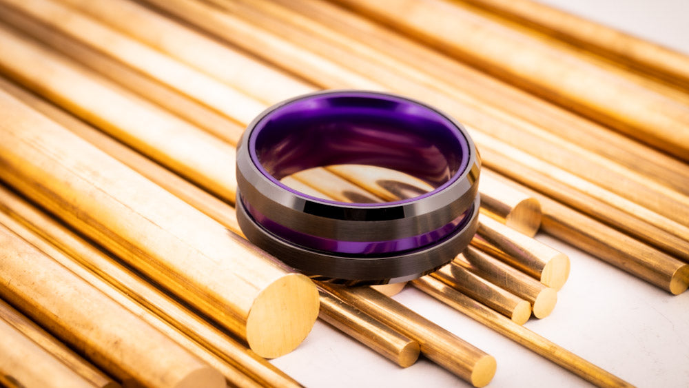 A purple wedding band on a gold industrial background.