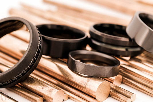 Black titanium rings on a gold industrial background.
