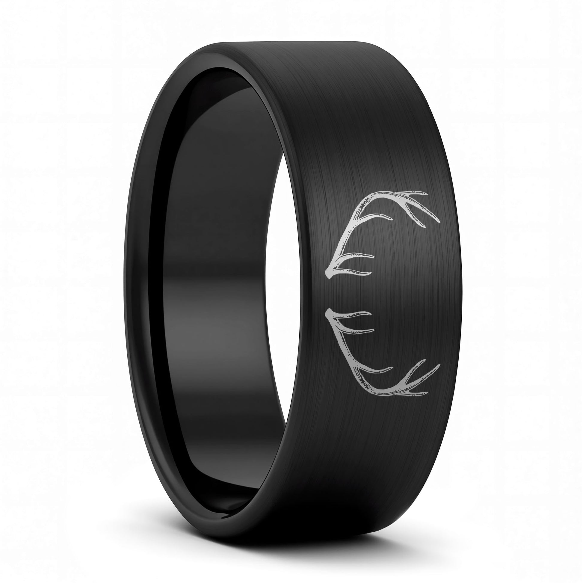 A antler engraved brushed black tungsten men's wedding band displayed on a plain white background.