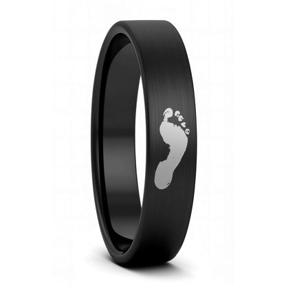 A custom footprint brushed black tungsten women's wedding band displayed on a plain white background.