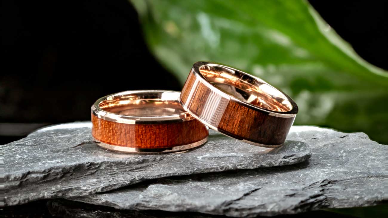 Two stacked rose gold wood inlay men's wedding bands