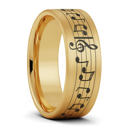 A music notes brushed gold tungsten men's wedding band displayed on a plain white background.
