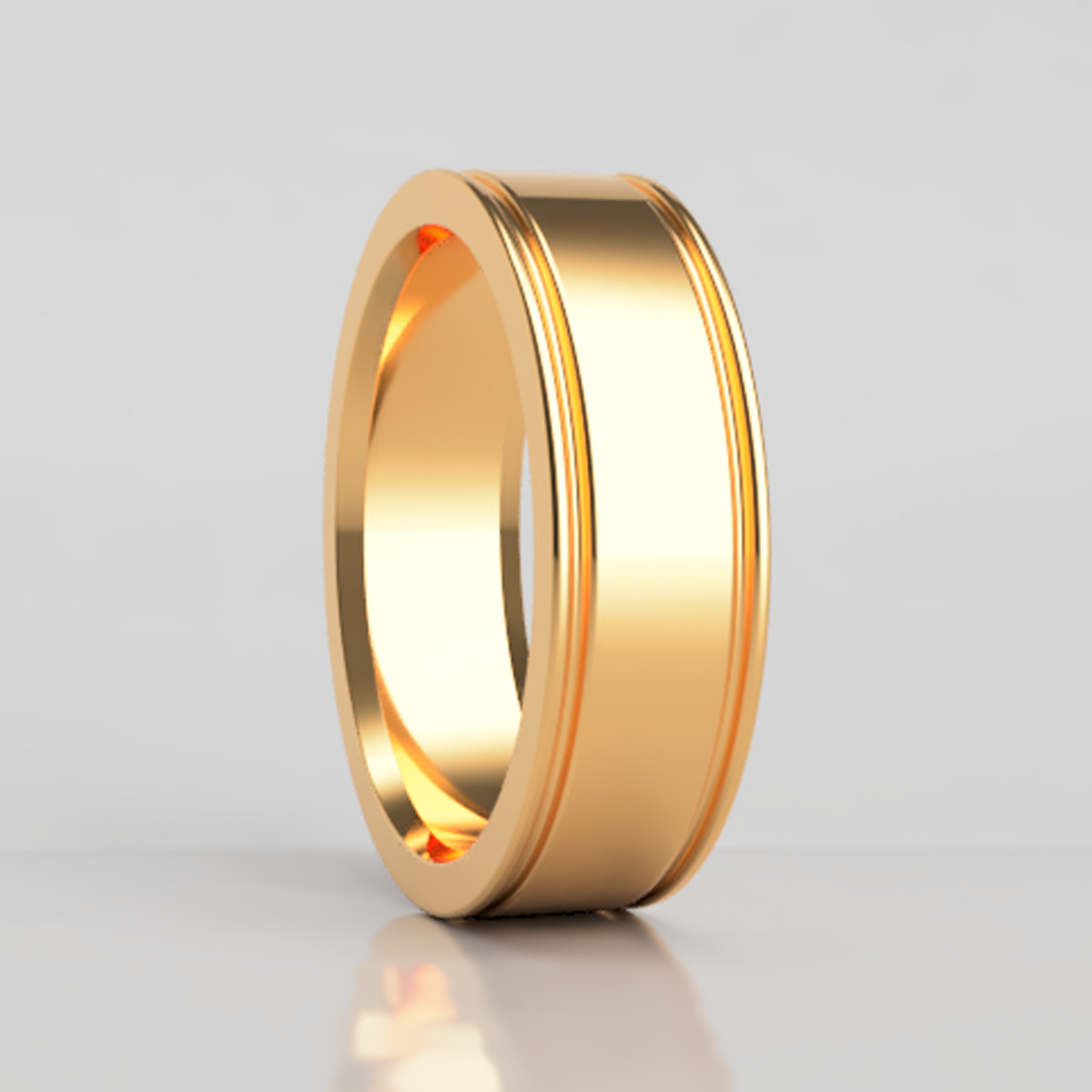 A 18k gold wedding band with grooved edges displayed on a neutral white background.