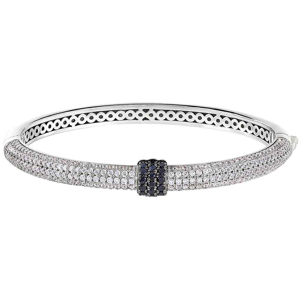 A bangle bracelet with black & white simulated diamonds displayed on a neutral white background.