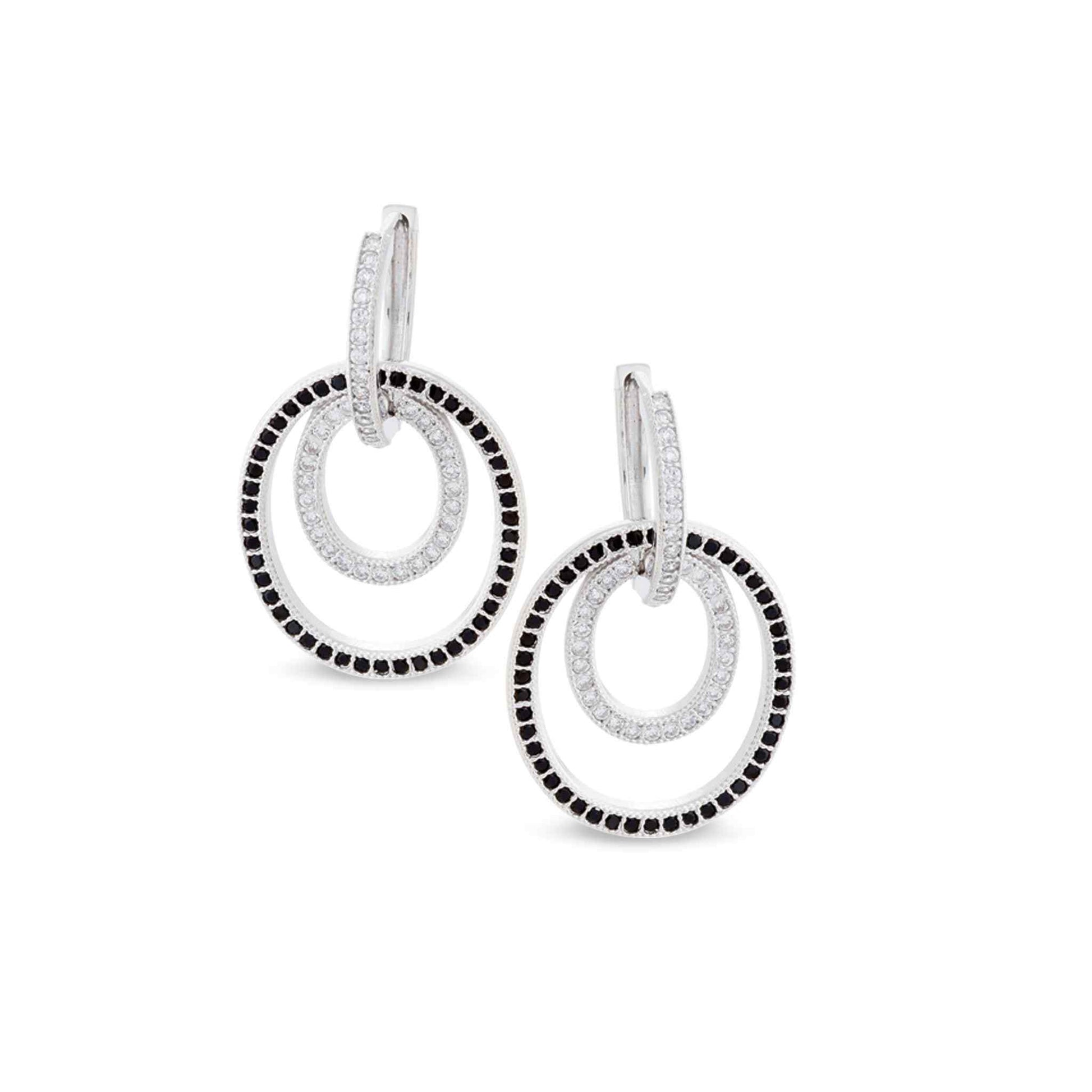 A black & white interlocking huggie earrings with simulated diamonds displayed on a neutral white background.