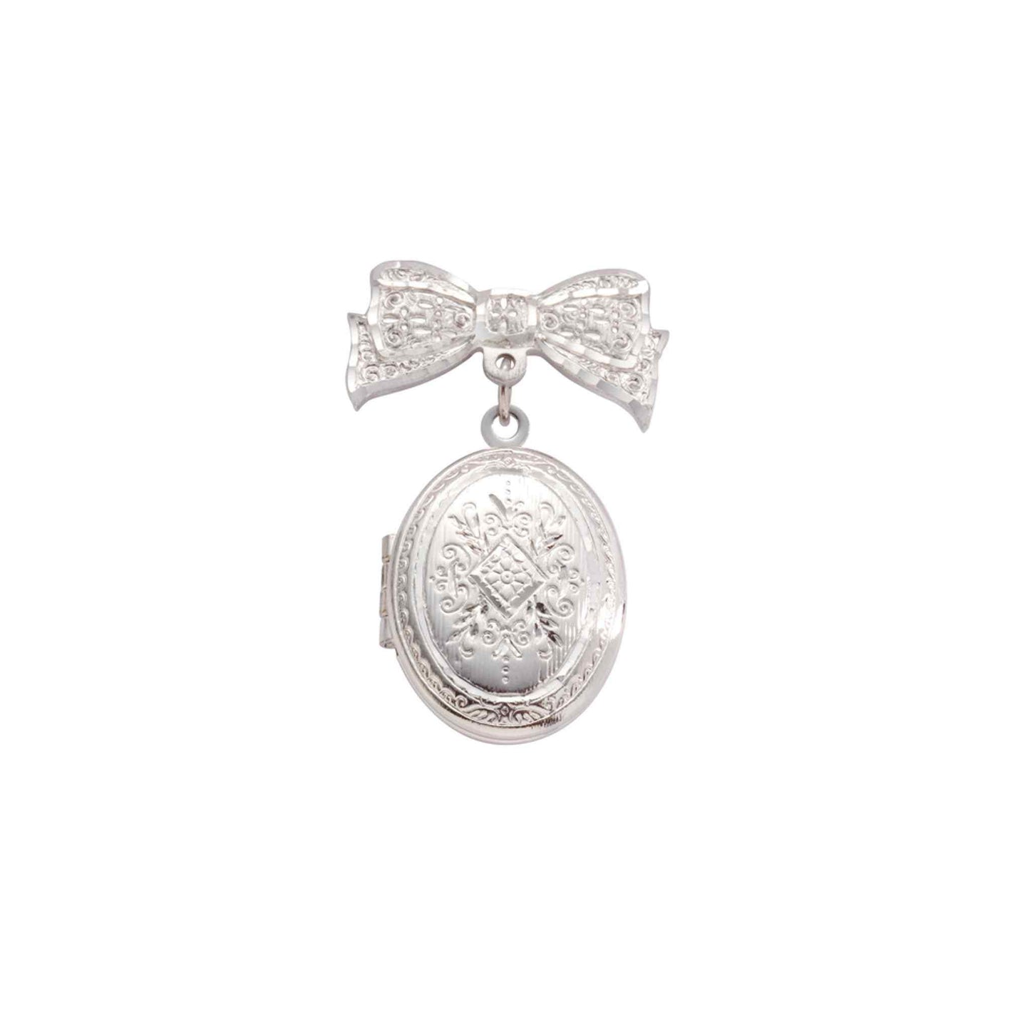 A bow pin and oval locket with bezel inserts displayed on a neutral white background.