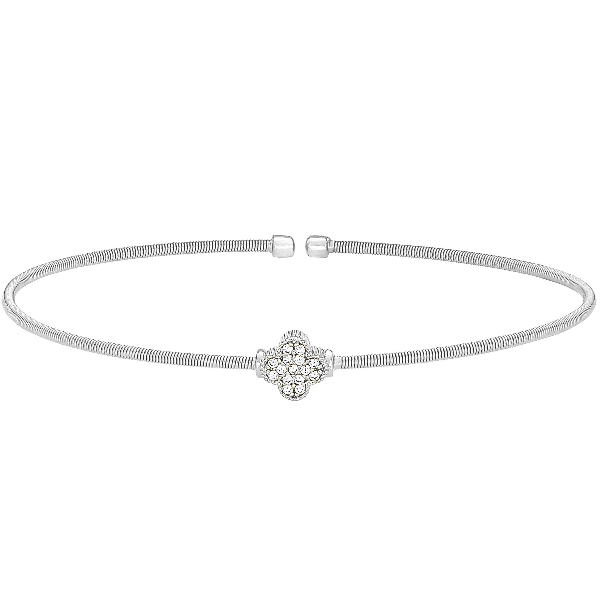 A clover design flexible cable bracelet with simulated diamonds displayed on a neutral white background.