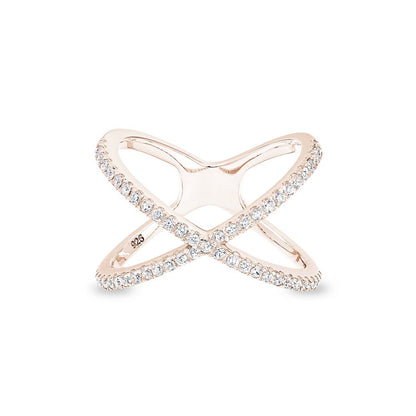 A criss cross negative space women's ring with simulated diamonds displayed on a neutral white background.