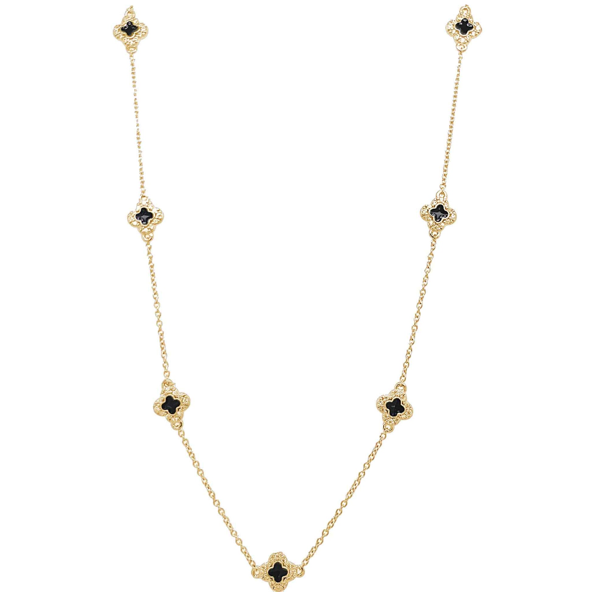 A enamel clover station necklace with simulated diamonds displayed on a neutral white background.