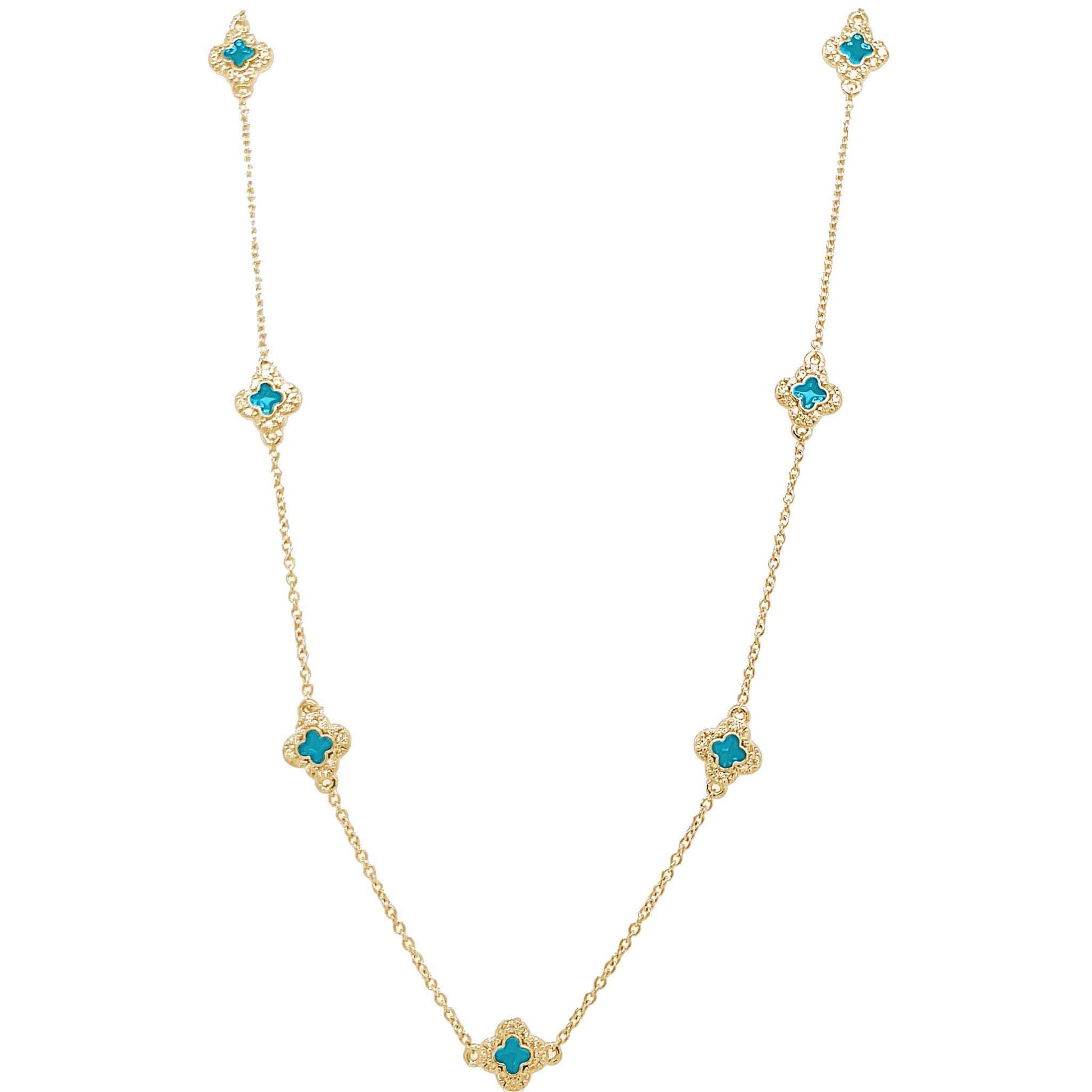 A enamel clover station necklace with simulated diamonds displayed on a neutral white background.