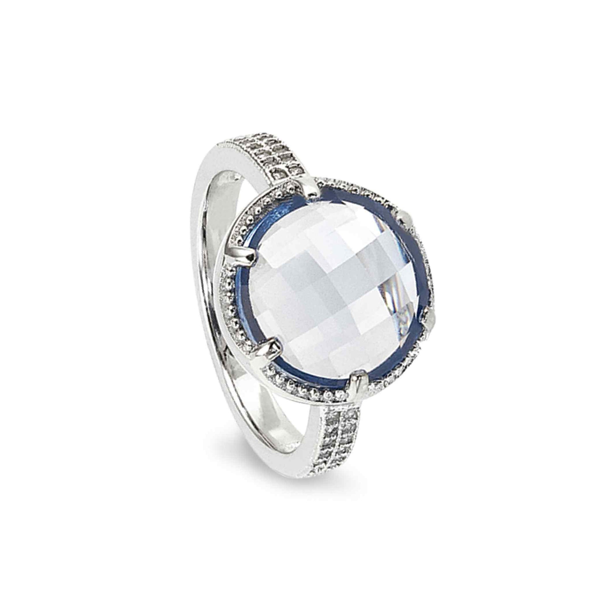 A facet cut blue ring with simulated diamonds displayed on a neutral white background.
