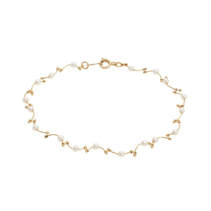 A floating pearl wave bracelet displayed on a neutral white background.