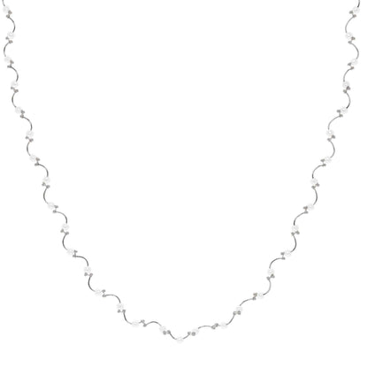 A floating pearl wave necklace displayed on a neutral white background.