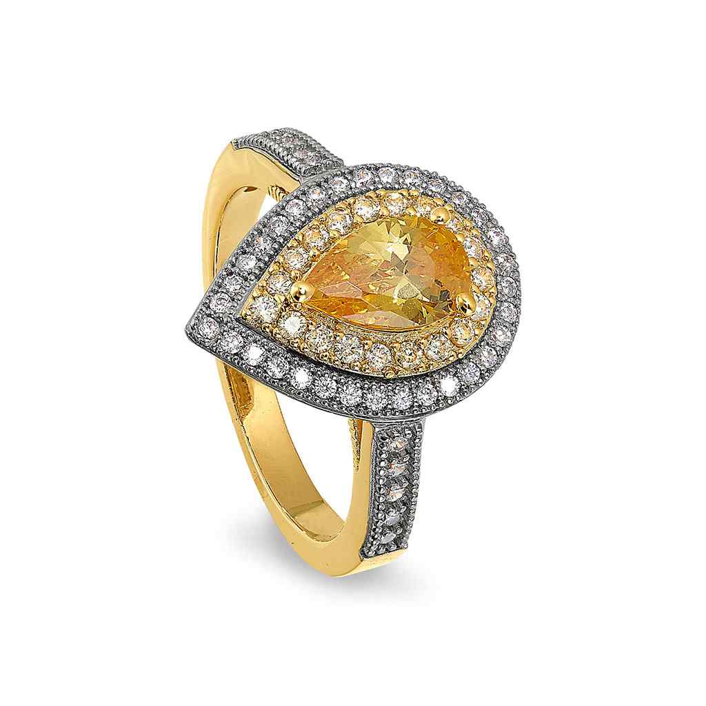 A pear shaped gold ring with canary colored stone & simulated diamonds displayed on a neutral white background.