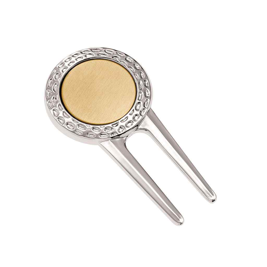 A golf divot repair tool with ball marker displayed on a neutral white background.