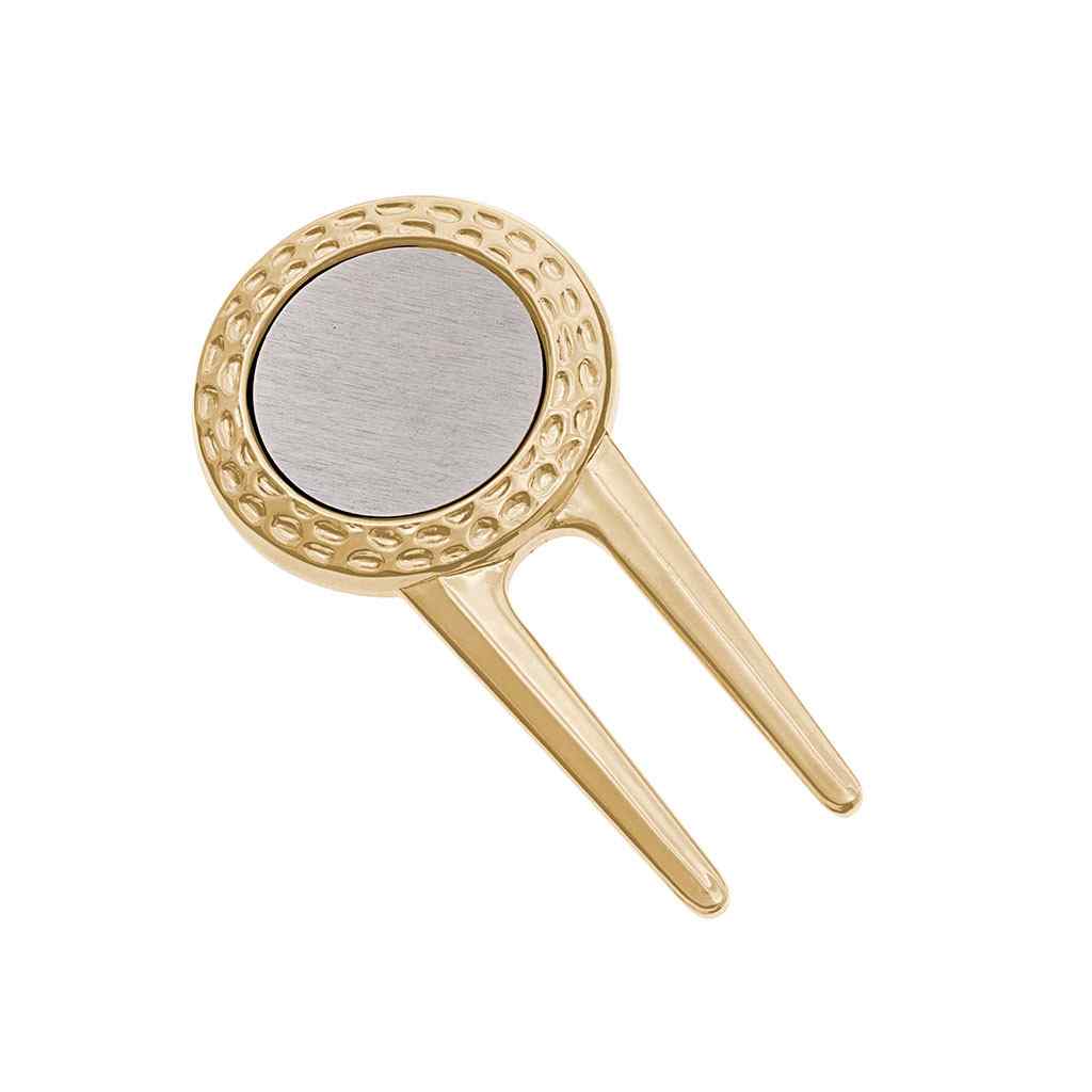 A golf divot repair tool with ball marker displayed on a neutral white background.