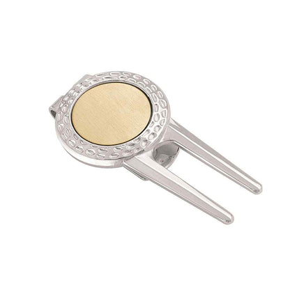 A golf divot repair tool money clip with ball marker displayed on a neutral white background.