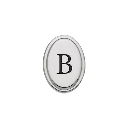 A black epoxy custom initial tie tack displayed on a neutral white background.