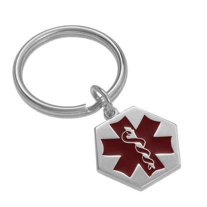 A medical key ring with red epoxy displayed on a neutral white background.