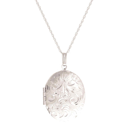 A oval tapestry locket with bezel inserts displayed on a neutral white background.