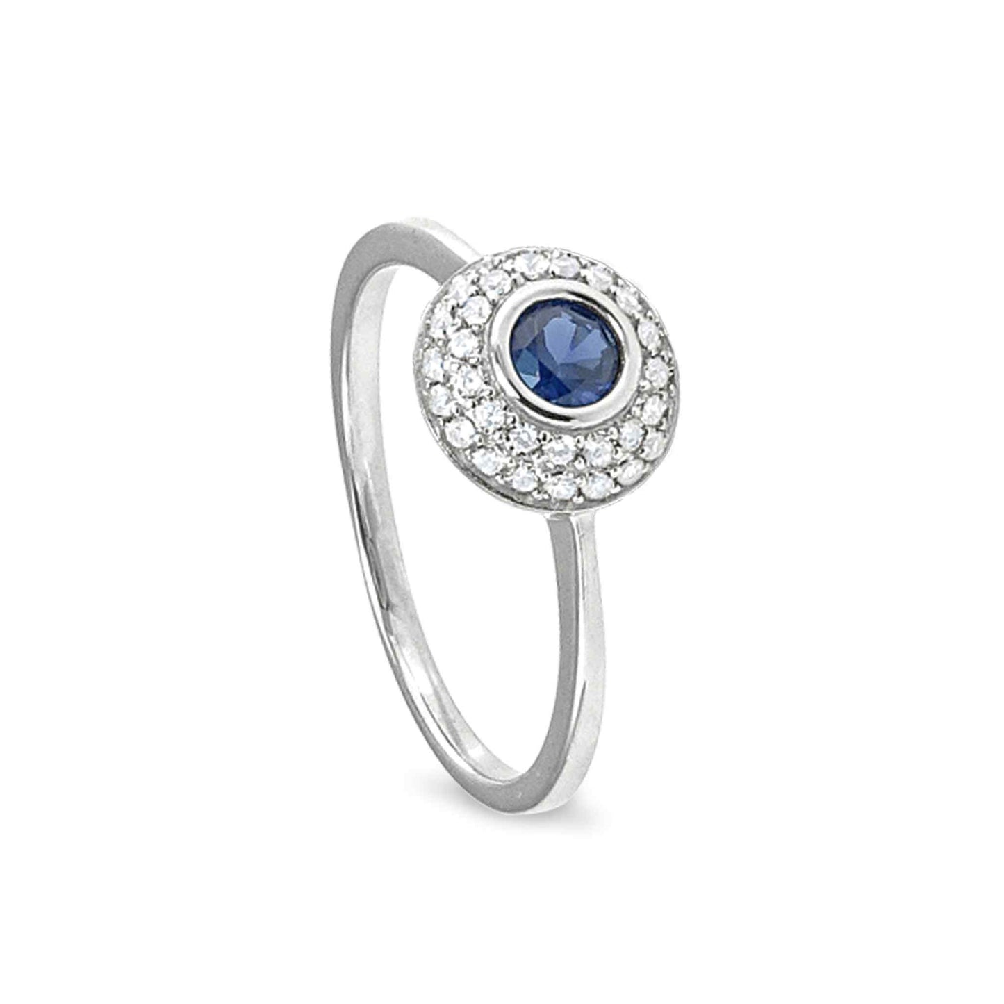 A ring with synthetic blue sapphire and simulated diamonds displayed on a neutral white background.