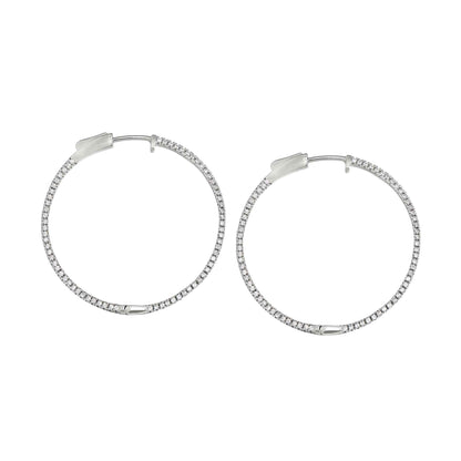 A side stone large hoop earrings with simulated diamonds displayed on a neutral white background.