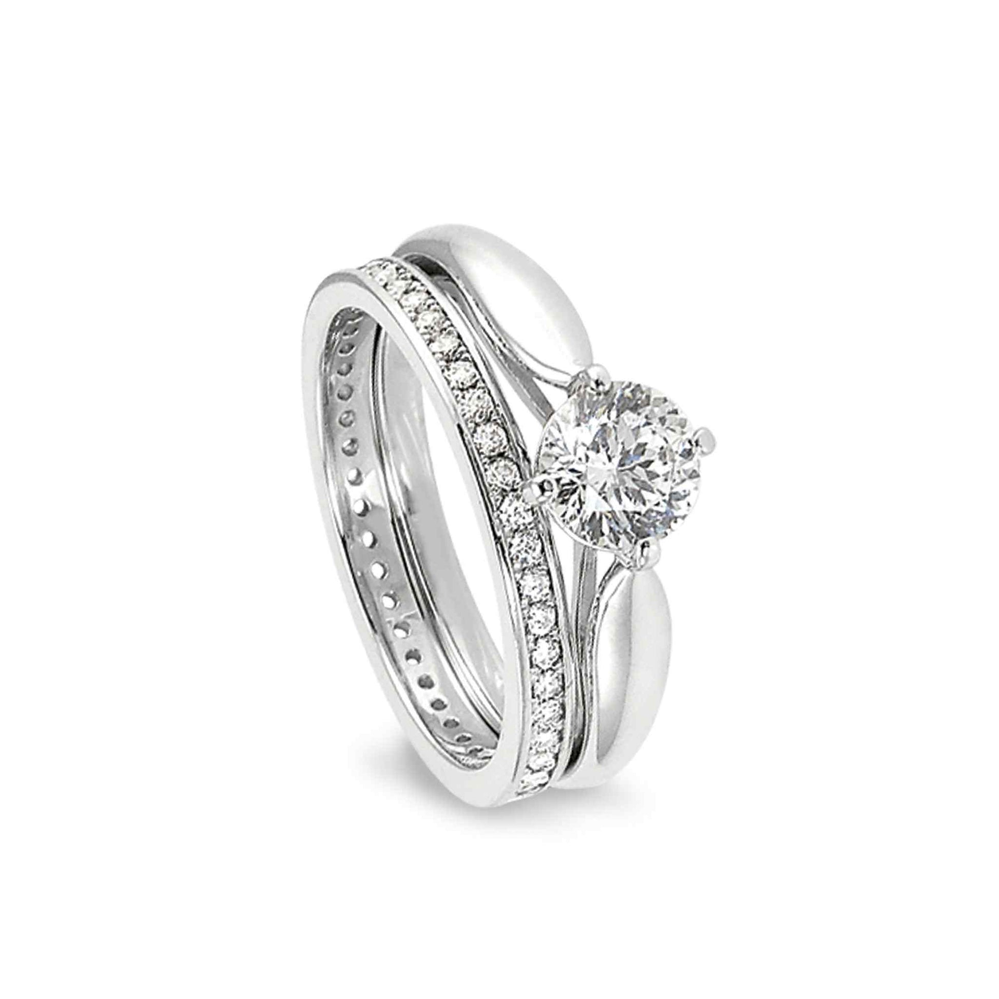 A solitaire wedding ring set with 100 facet simulated diamond displayed on a neutral white background.