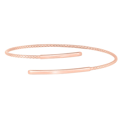 A spiral wrap negative space cable bracelet displayed on a neutral white background.