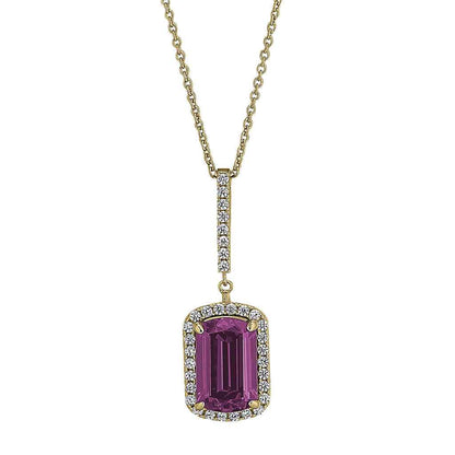 A sterling silver emerald cut pink stone necklace with simulated diamonds displayed on a neutral white background.