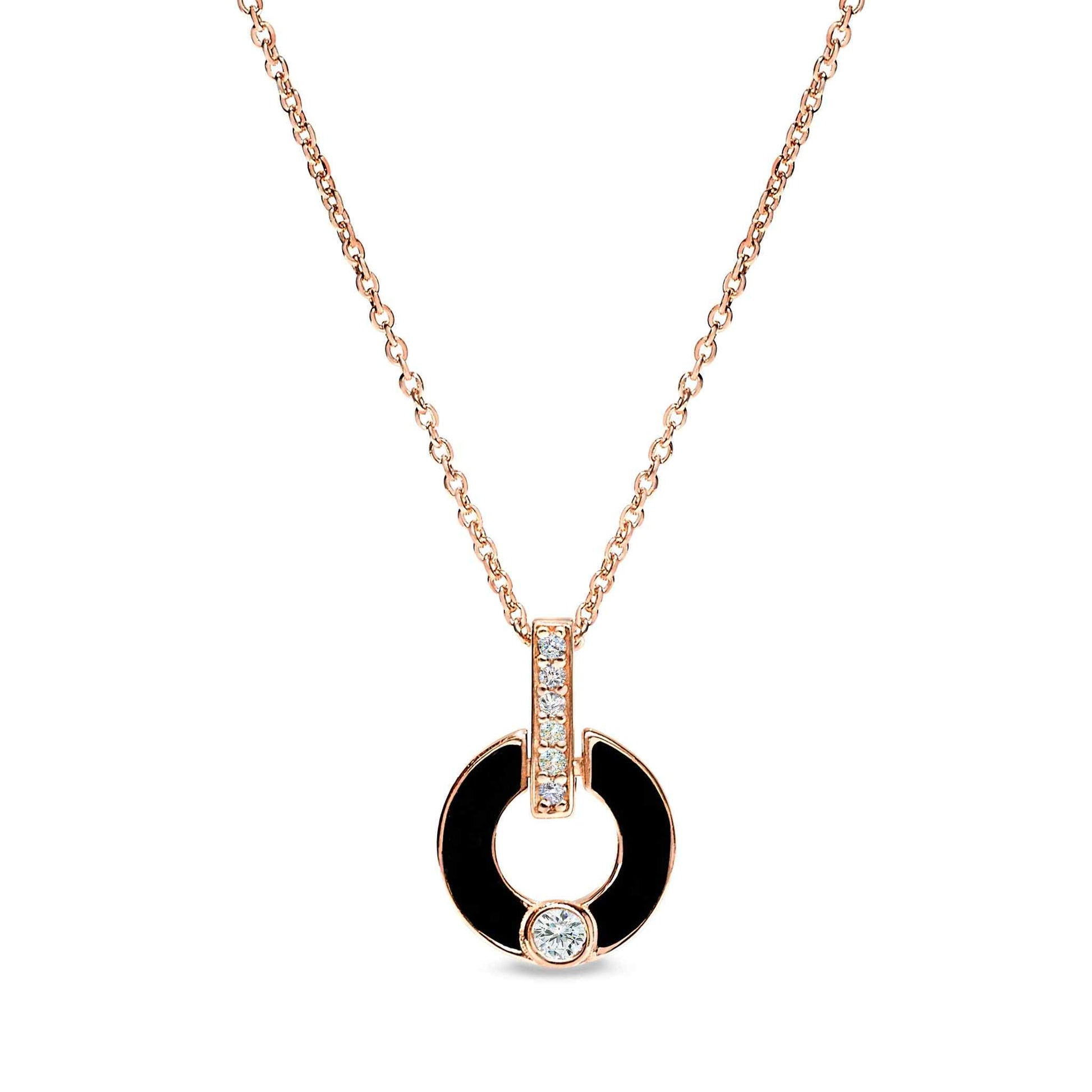 A sterling silver round drop necklace with black enamel and simulated diamonds displayed on a neutral white background.