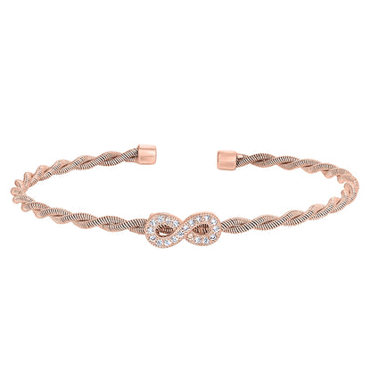 A infinity symbol twisted flexible cable bracelet with simulated diamonds displayed on a neutral white background.