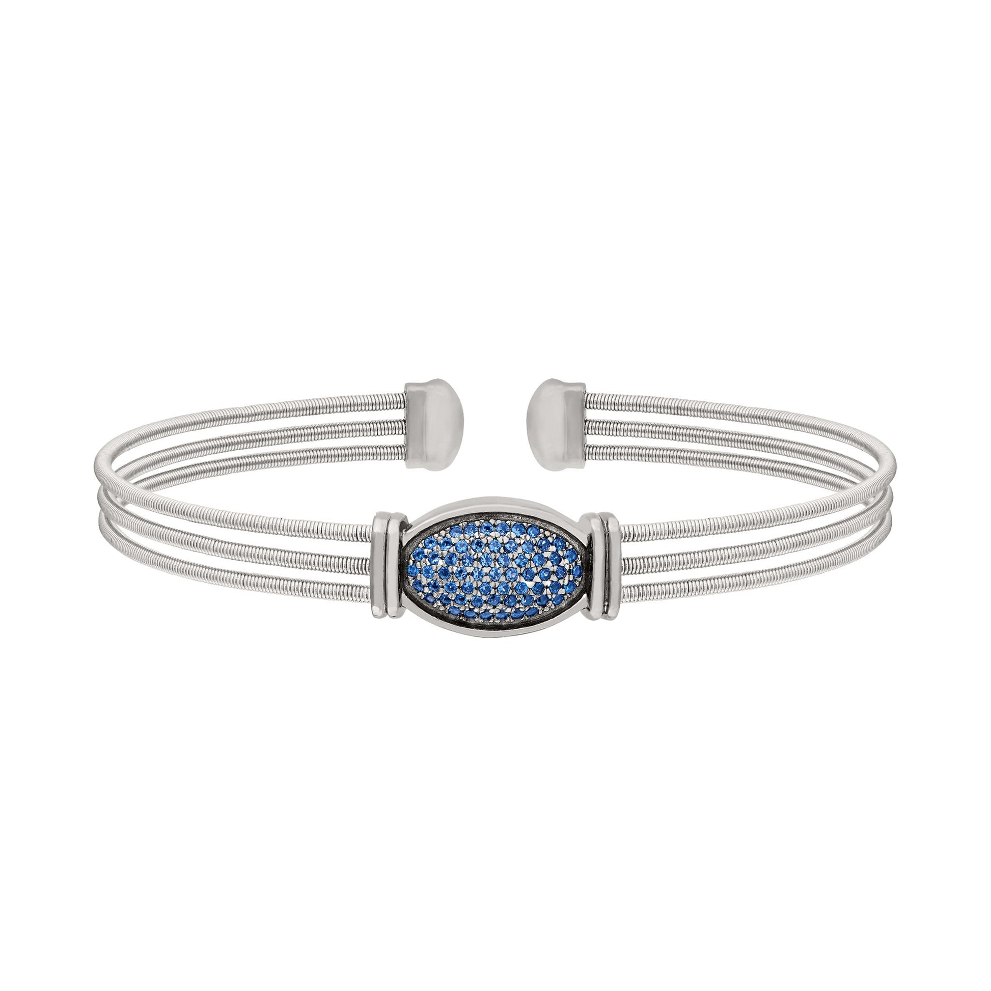 A three cable bracelet with oval gemstone accents displayed on a neutral white background.