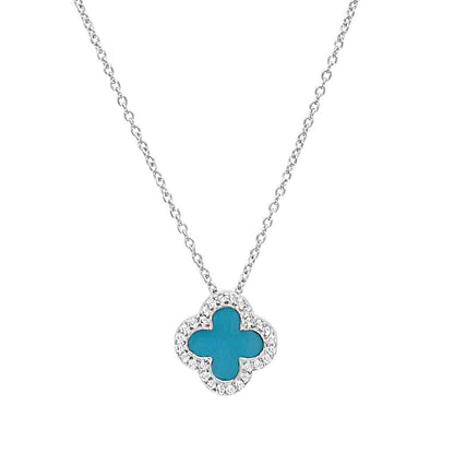 A turquoise enamel clover necklace with simulated diamonds displayed on a neutral white background.