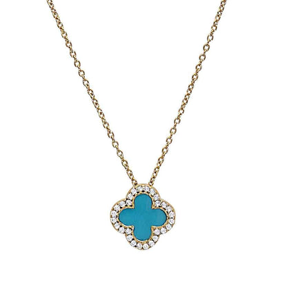 A turquoise enamel clover necklace with simulated diamonds displayed on a neutral white background.