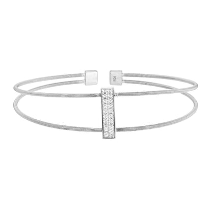 A negative space cable bracelet with simulated diamond vertical bar displayed on a neutral white background.