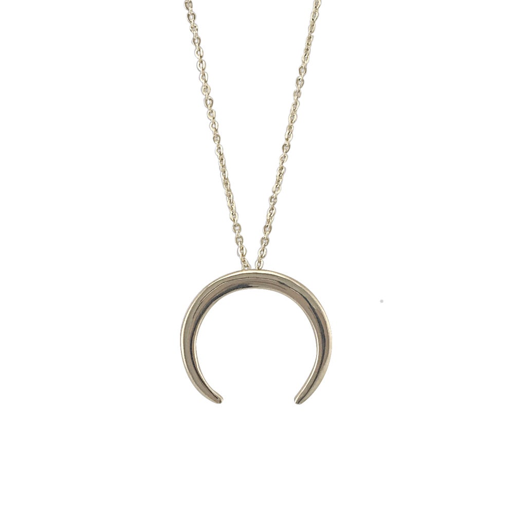 A upside down crescent moon necklace displayed on a neutral white background.