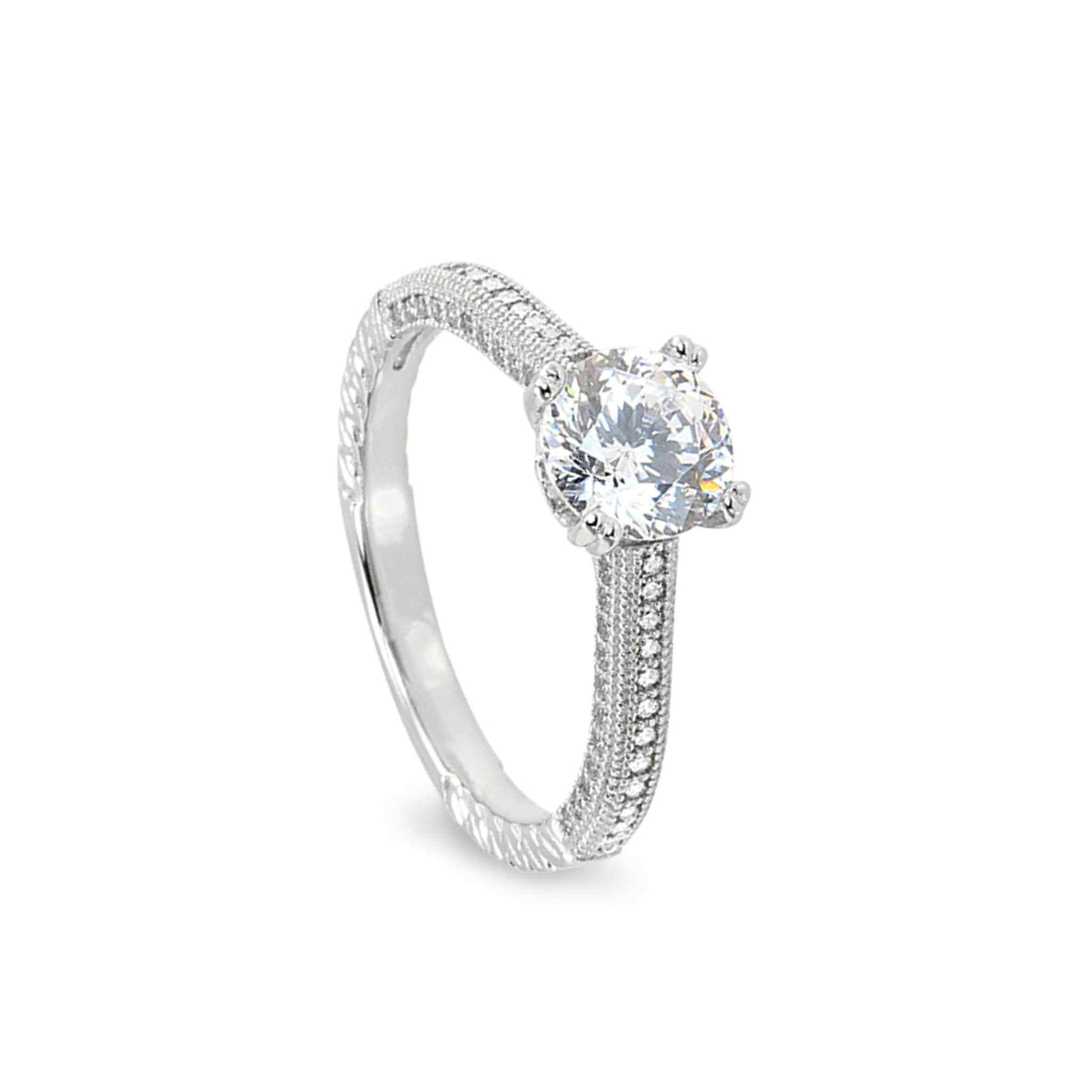 A vintage-style engagement ring with 100 facet simulated diamond displayed on a neutral white background.