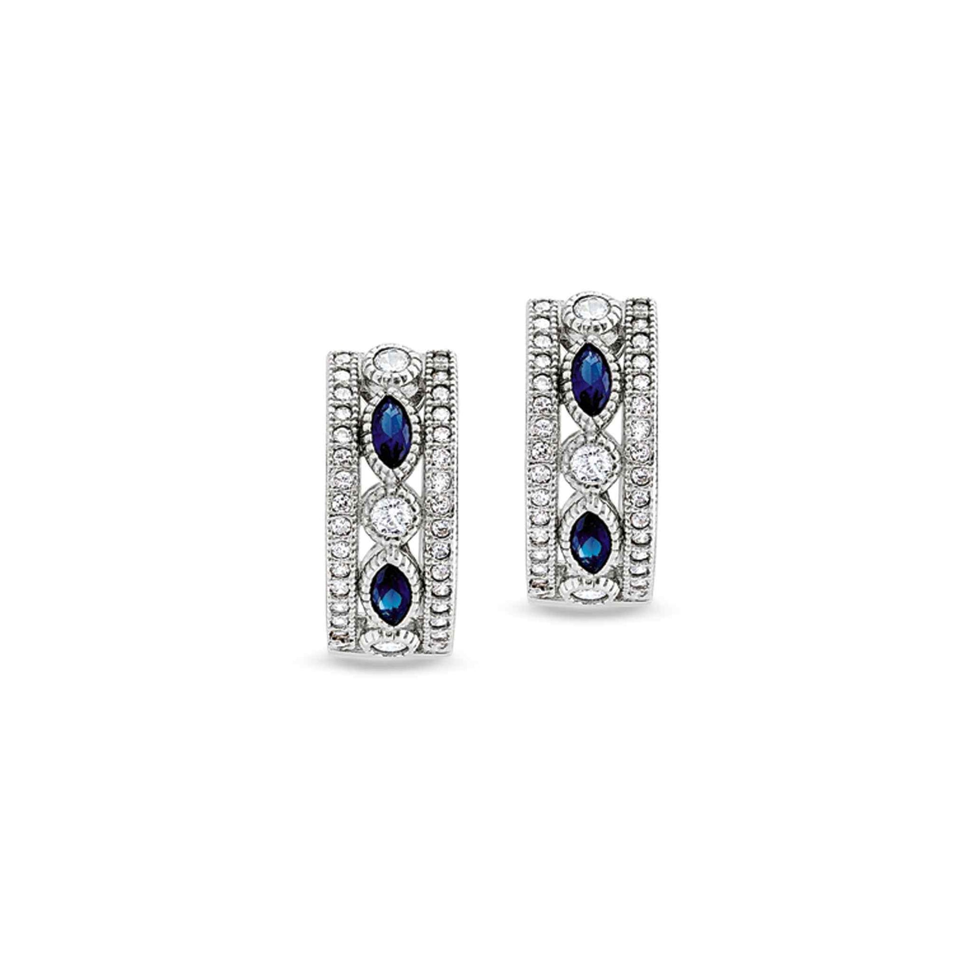 A vintage-style huggie earrings with synthetic blue sapphire & simulated diamonds displayed on a neutral white background.